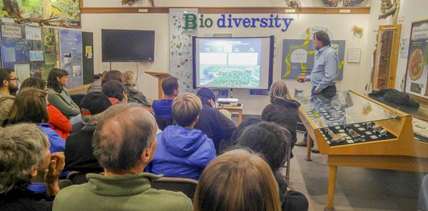 an audience at a monthly speaker series - watching a presentation