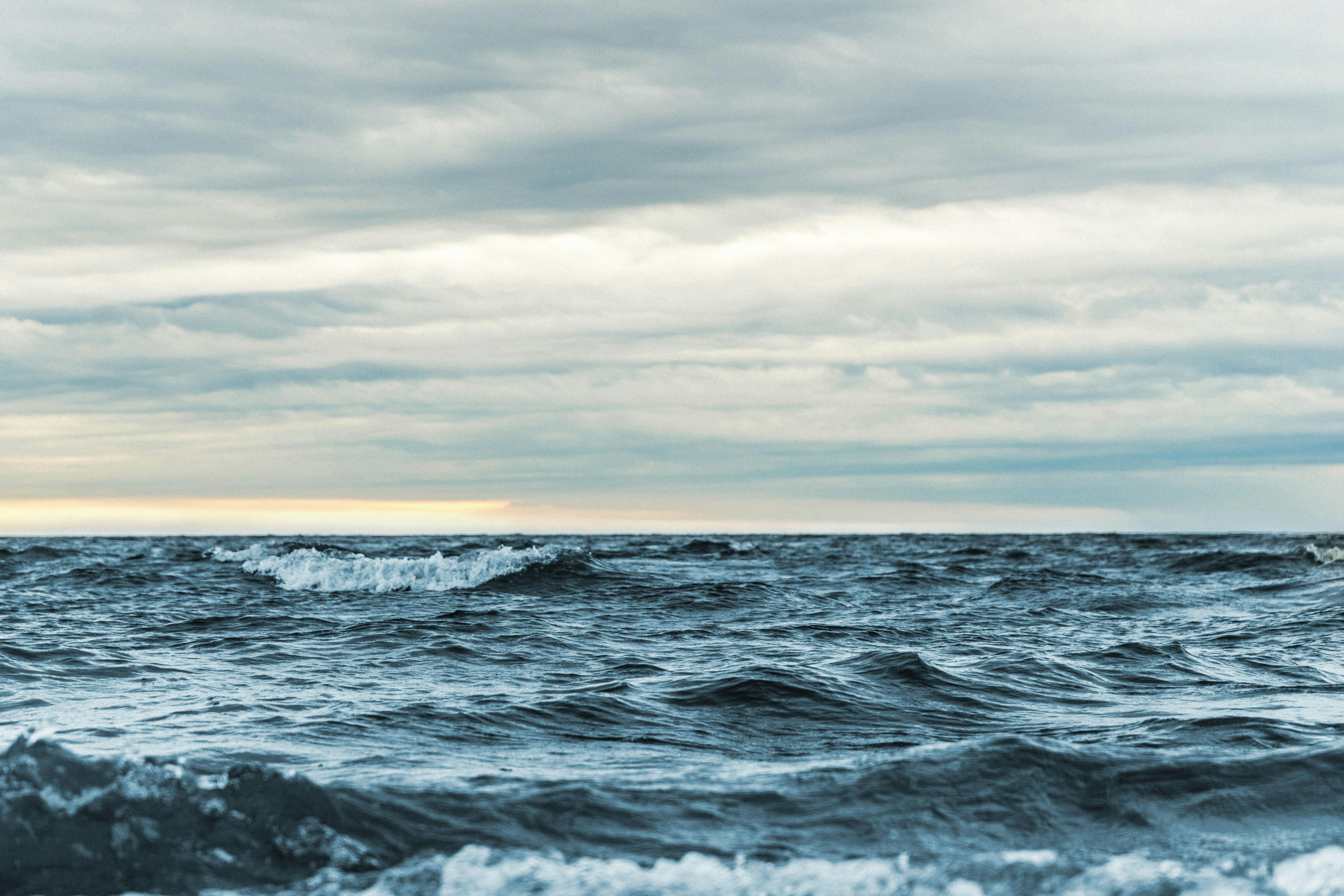 picture of ocean with cloudy sky