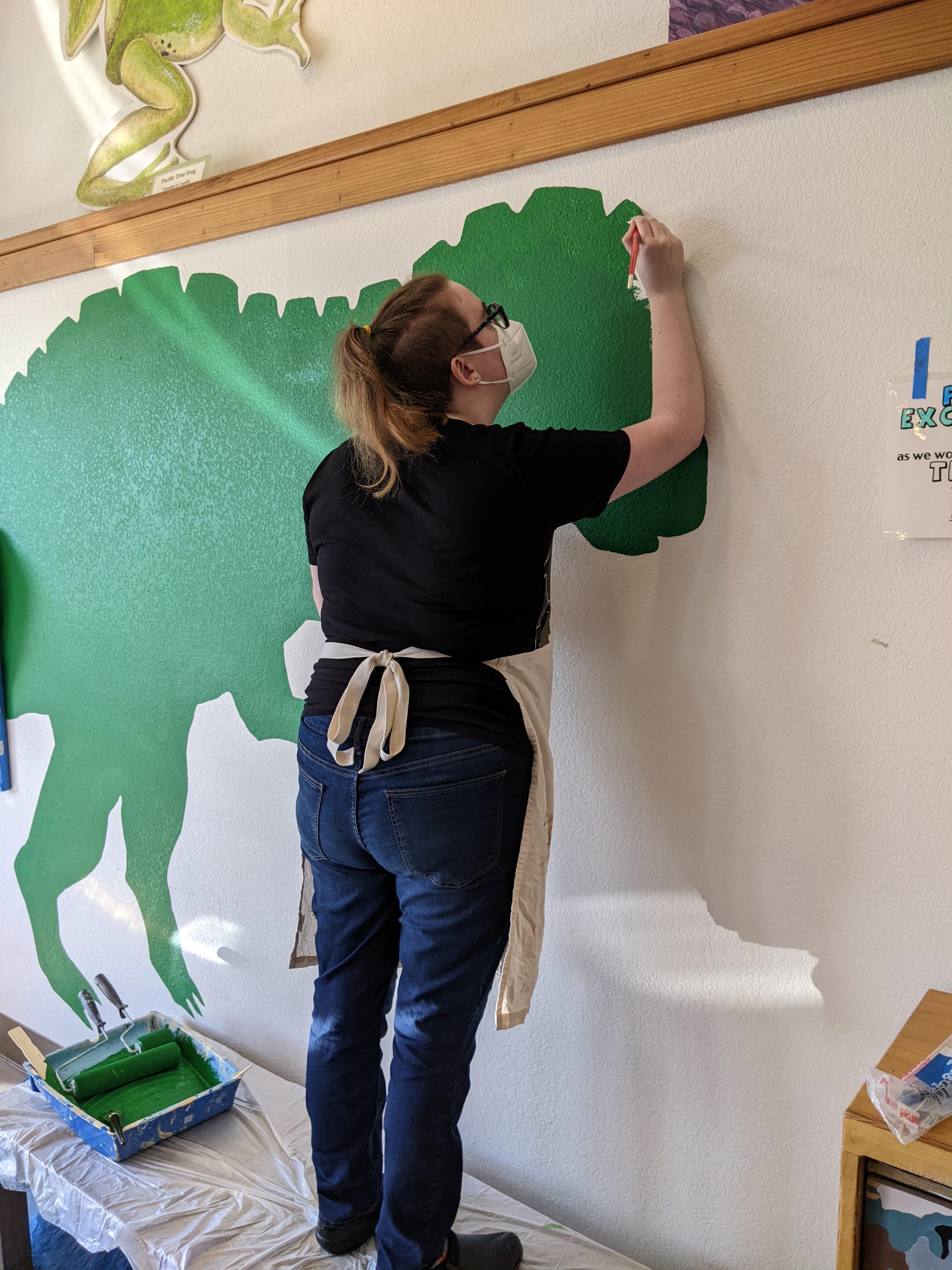 Dino mural painting in action 