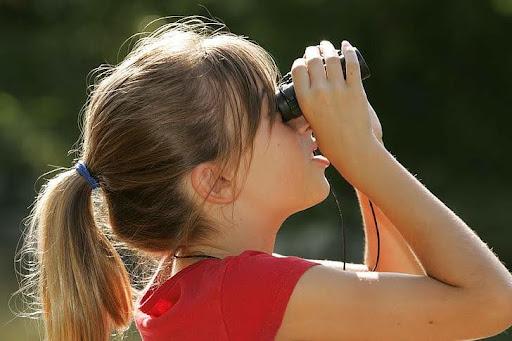kid looking through binoculars