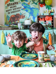 two kids at a dino themed table