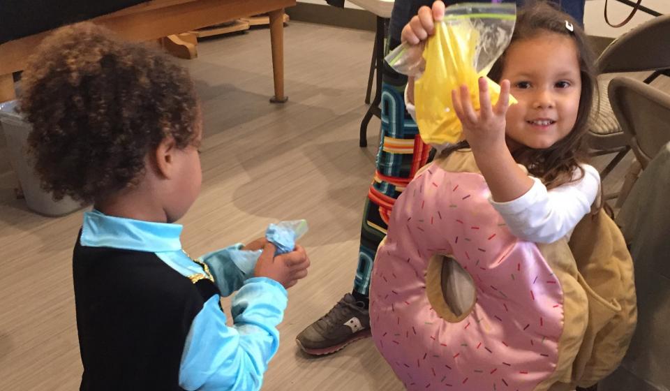 Child show the slime they just made 